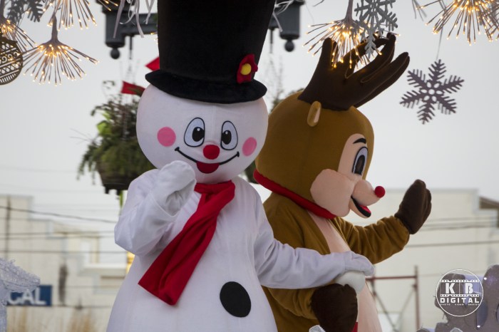 Frosty and Rudolph wave at the crowd.
