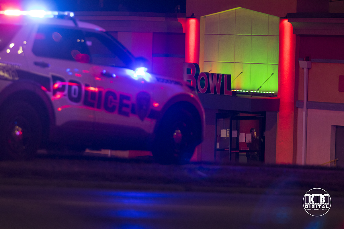 Police inside bowling alley after fatal shooting.